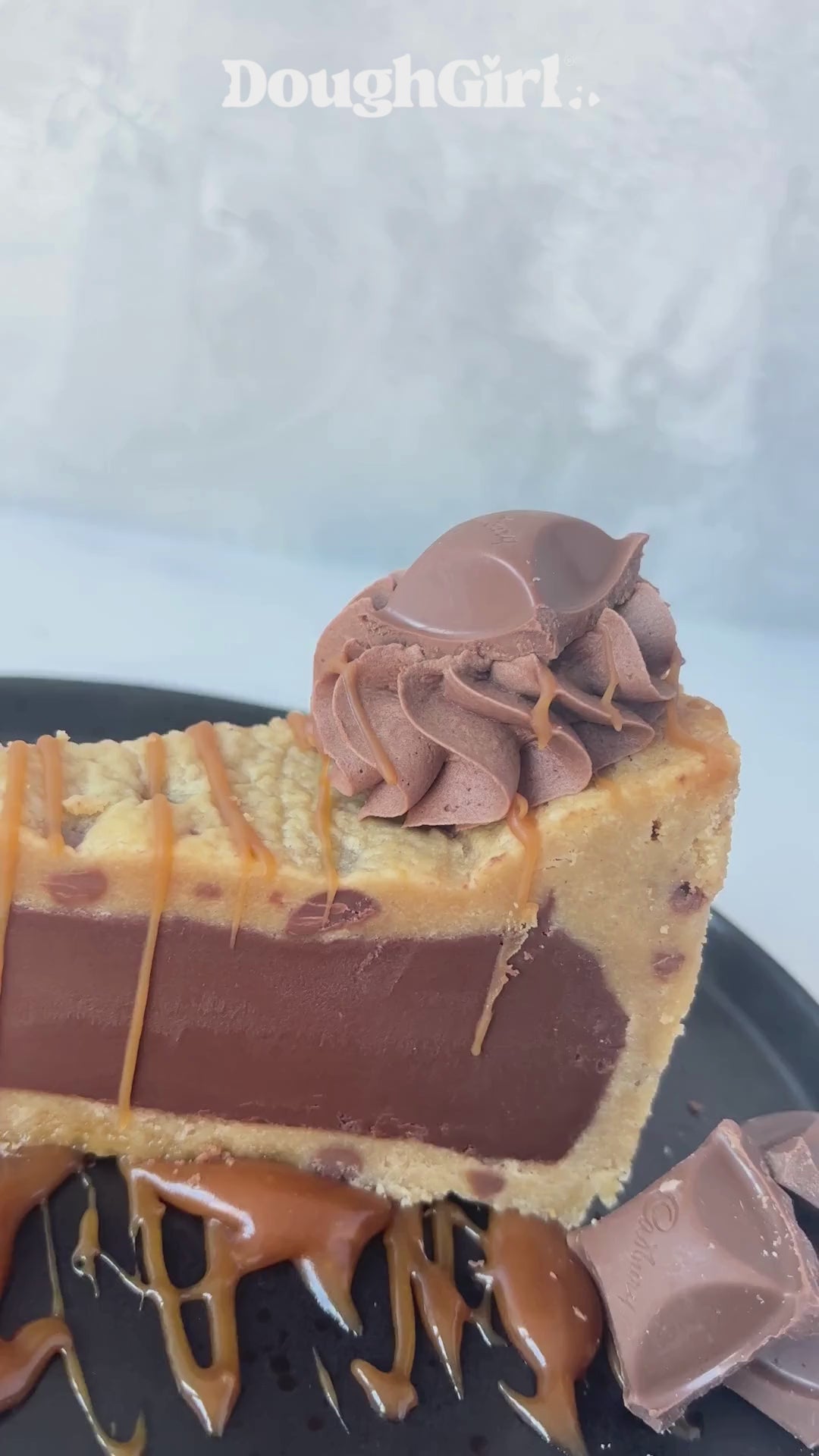 DoughGirl Caramel Cookie Pie, with caramel drizzle, on a black plate