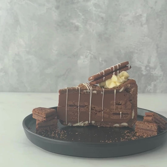 Bourbon Biscuit Cookie Pie by DoughGirl on a black plate, against a neutral background
