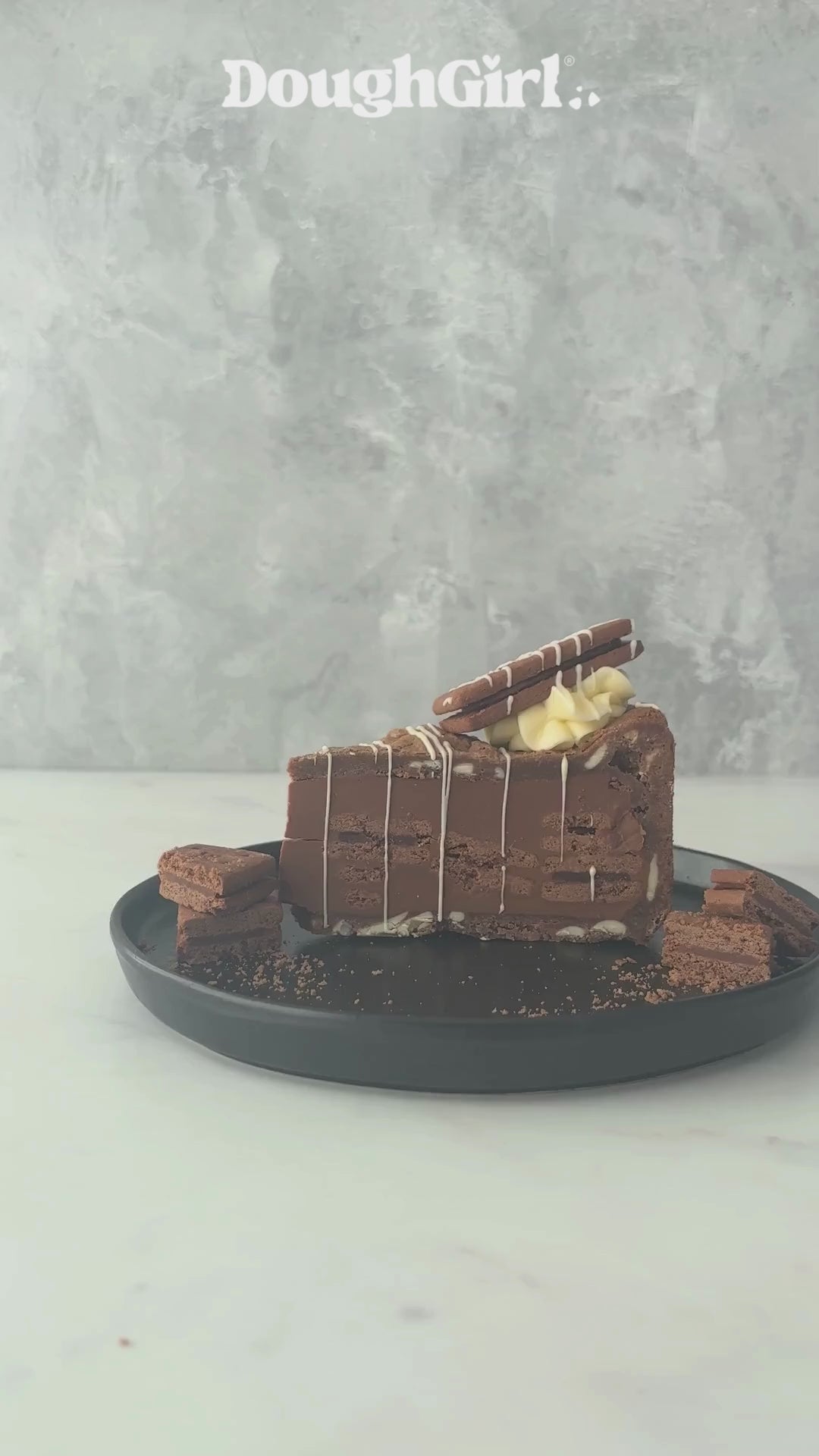 Bourbon Biscuit Cookie Pie by DoughGirl on a black plate, against a neutral background