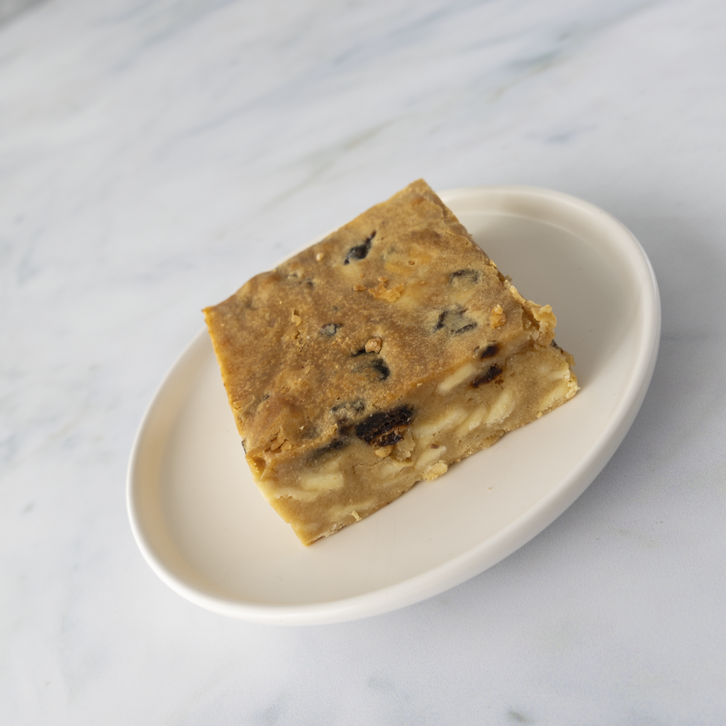 Buttery sticky toffee blondie traybake slice plated ready to serve