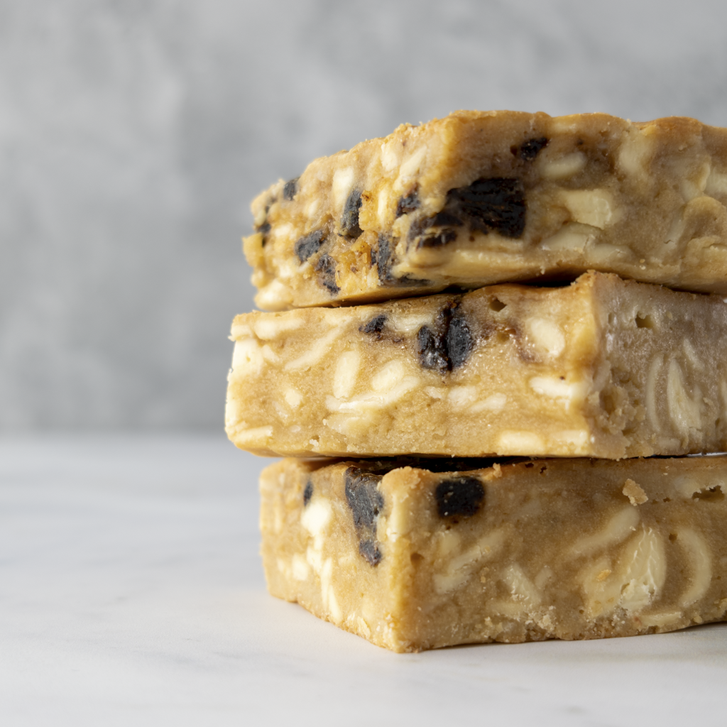 Zoom detail of buttery sticky toffee blondie with caramelised toffee chunks