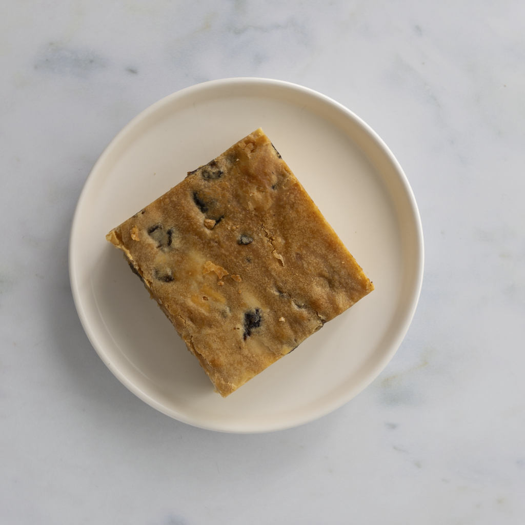 Indulgent sticky toffee blondie slab portion with golden top and chewy texture